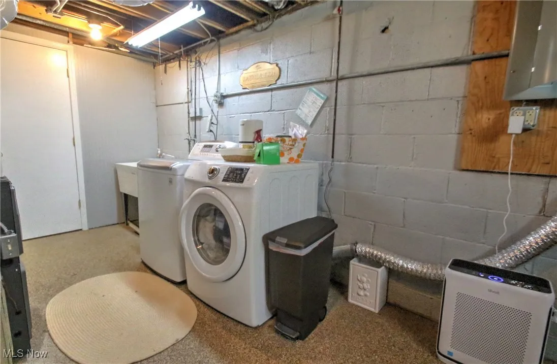Washroom with washer and clothes dryer