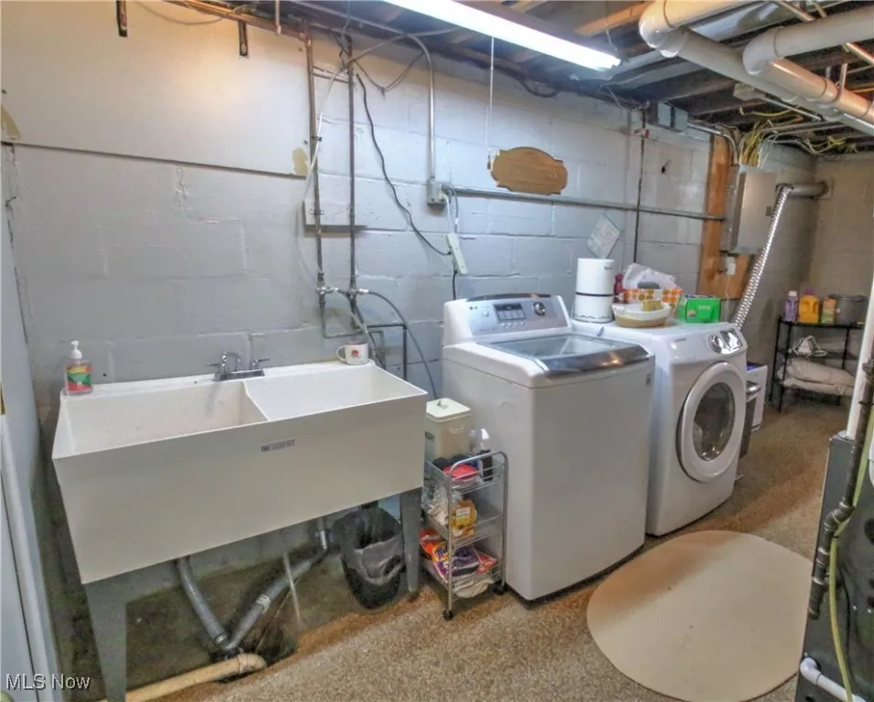 Washroom featuring washer and clothes dryer and electric panel