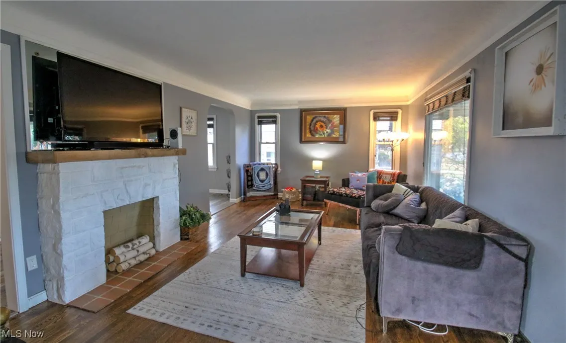 Living area with wood finished floors and a decorative fireplace