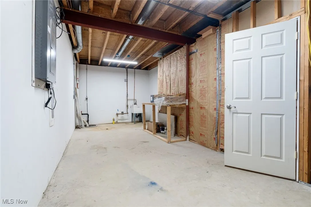 Unfinished below grade area with electric panel