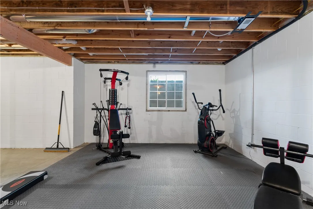 Exercise area featuring concrete block wall