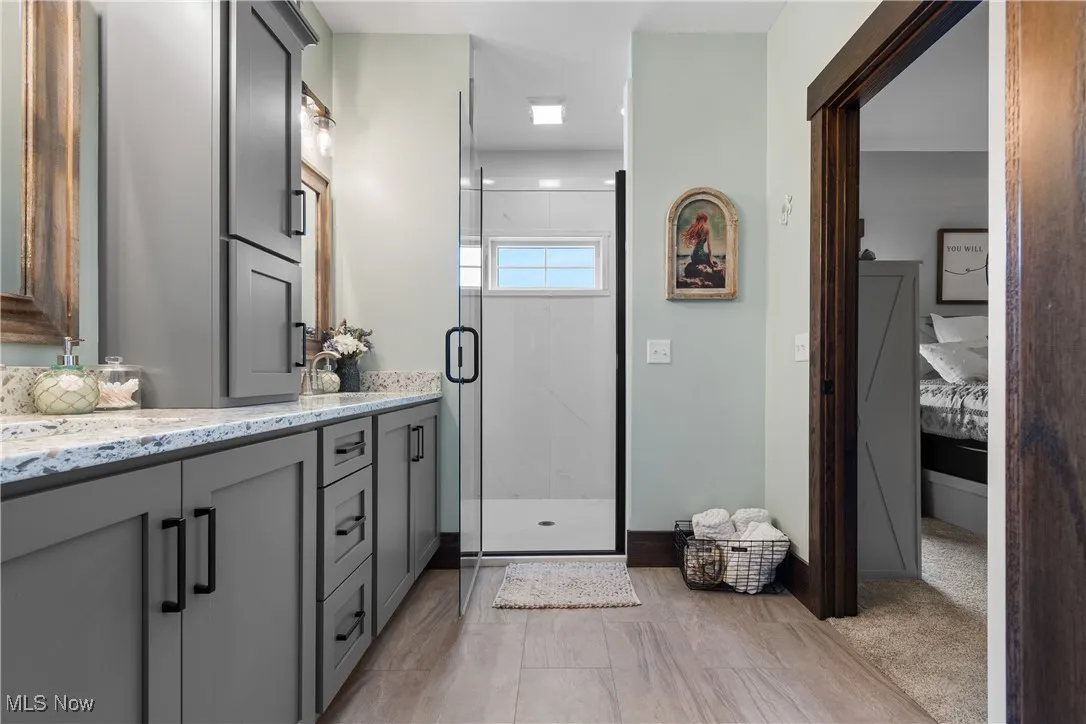 Bathroom with vanity and a shower stall