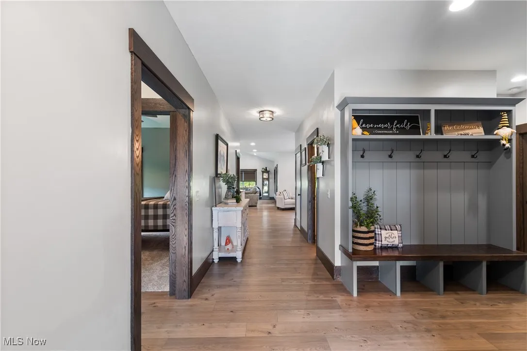 Mudroom featuring light wood finished floors and recessed lighting