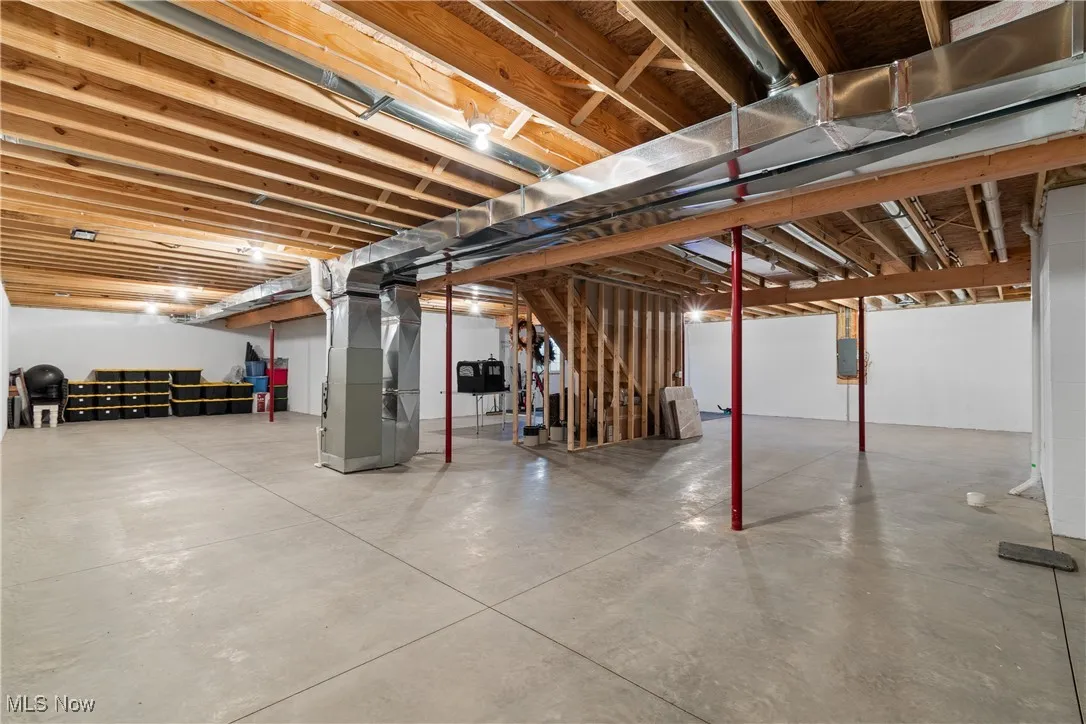 Unfinished below grade area featuring heating unit
