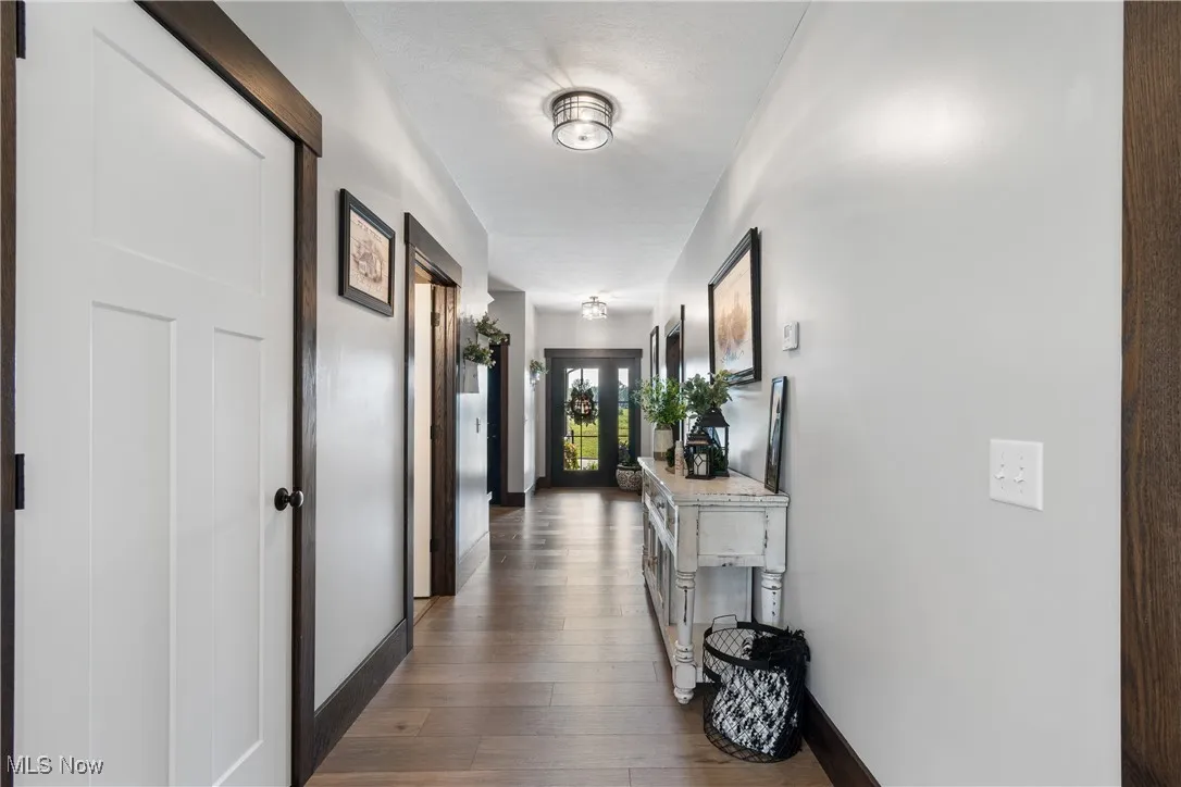 Hallway with baseboards and dark wood finished floors