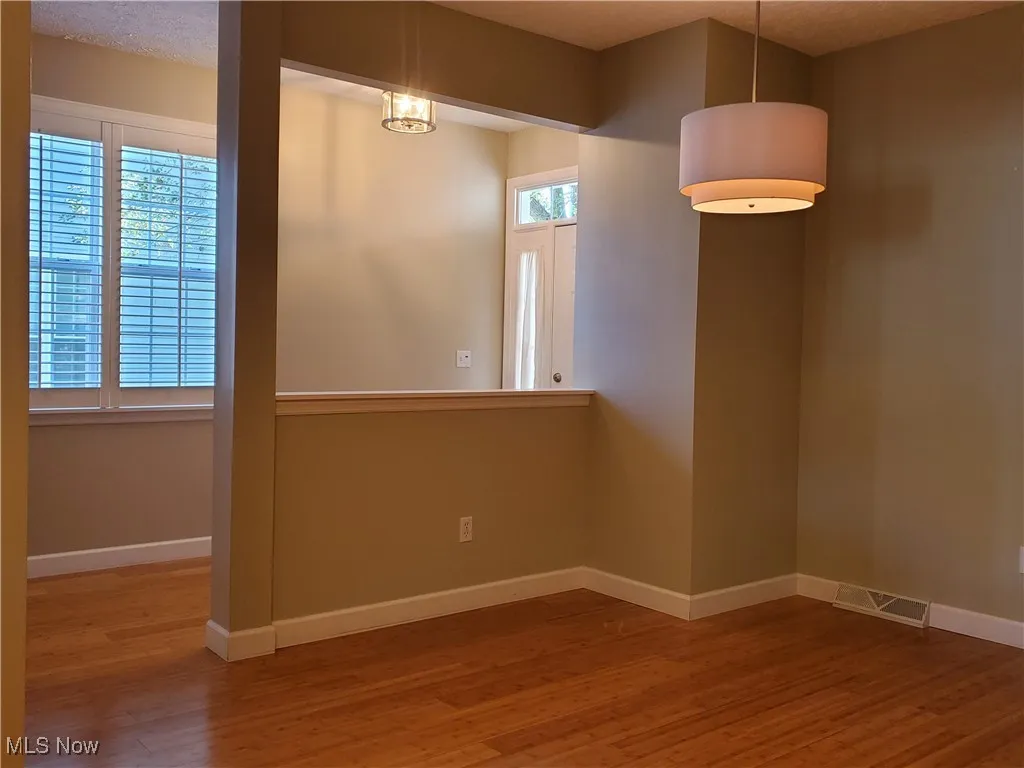 Unfurnished room with baseboards and light wood-style flooring