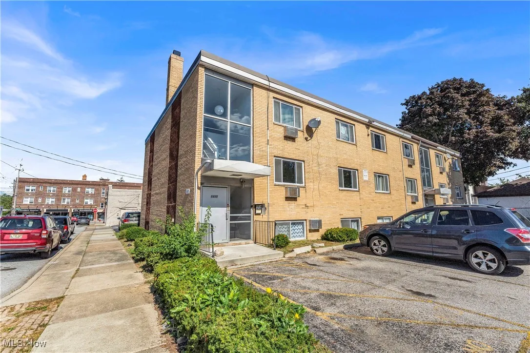 View of property with uncovered parking