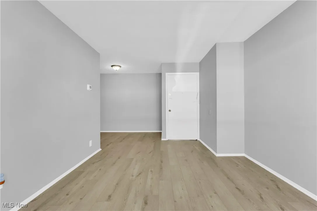 Empty room featuring light wood-type flooring and baseboards