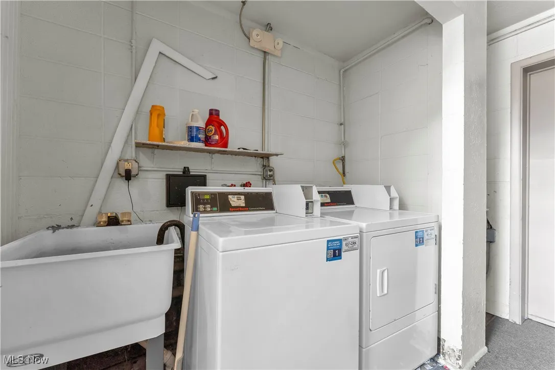 Communal laundry room with separate washer and dryer