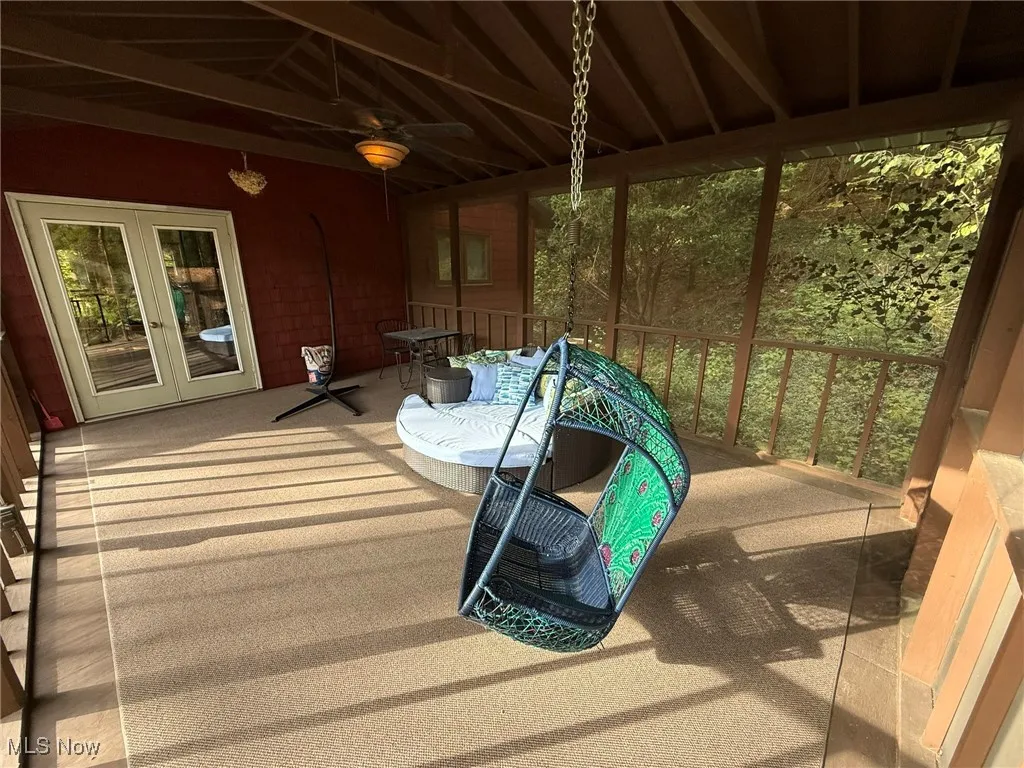 Deck featuring a ceiling fan, french doors, and a sunroom