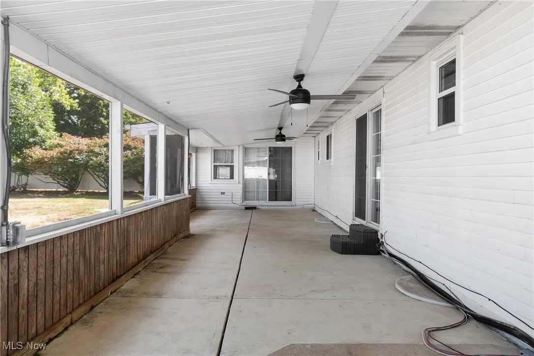 View of patio / terrace featuring ceiling fan and a sunroom