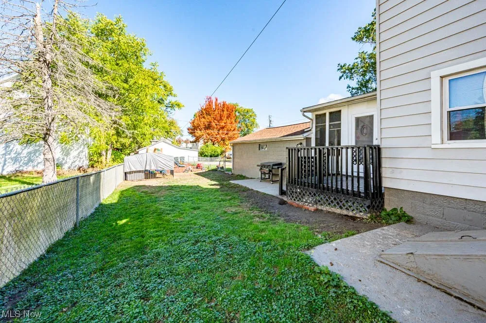 Fenced backyard with a wooden deck
