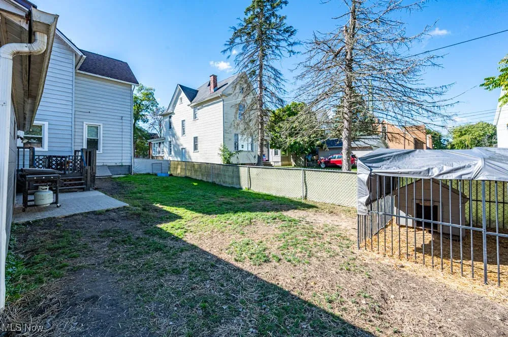 Fenced backyard featuring a residential view and a patio