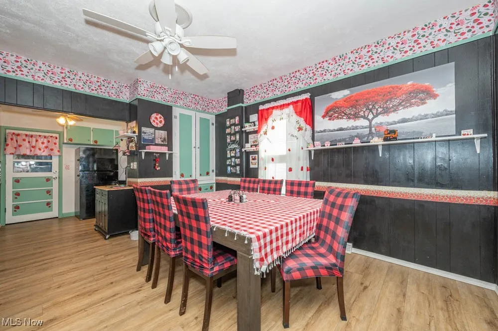 Dining area with light wood-style floors and baseboards