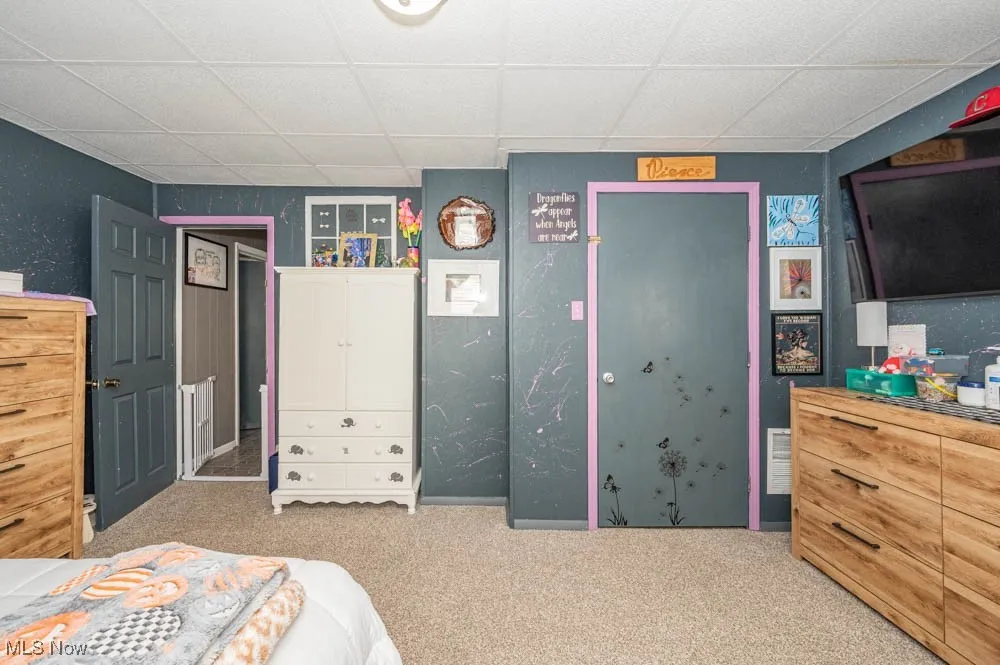 Bedroom featuring carpet and a paneled ceiling