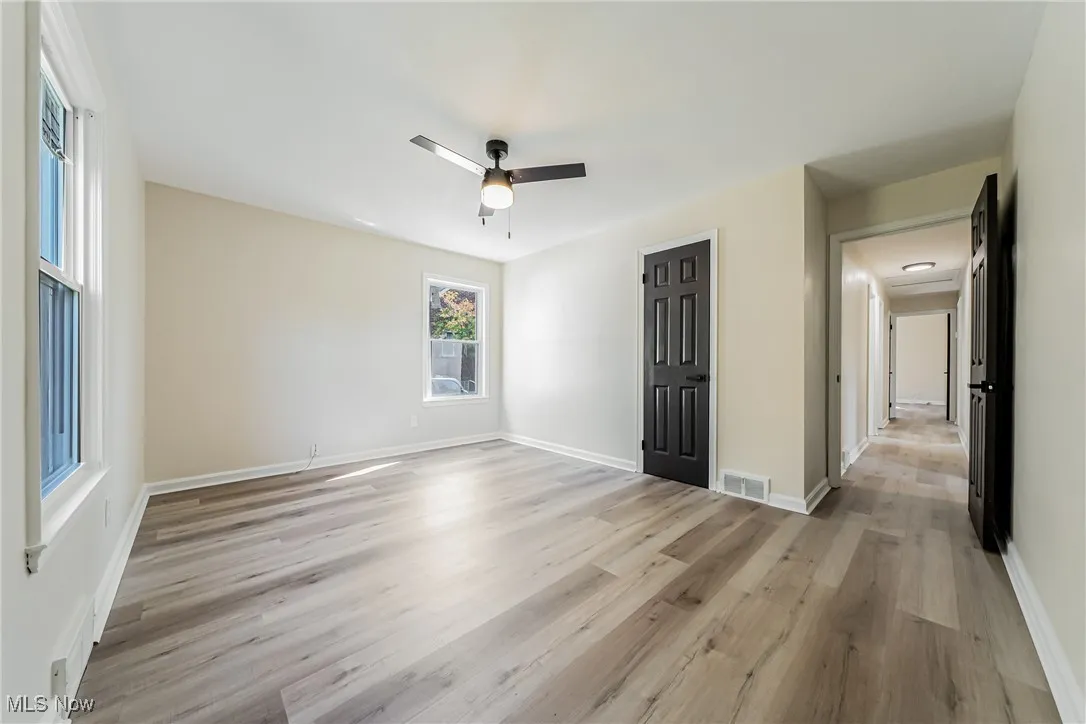 Unfurnished bedroom featuring light wood-style flooring, ceiling fan, and a closet