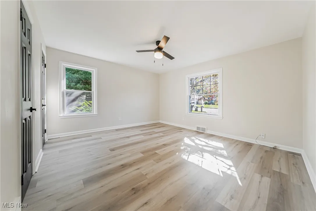 Spare room featuring light wood-type flooring and a ceiling fan