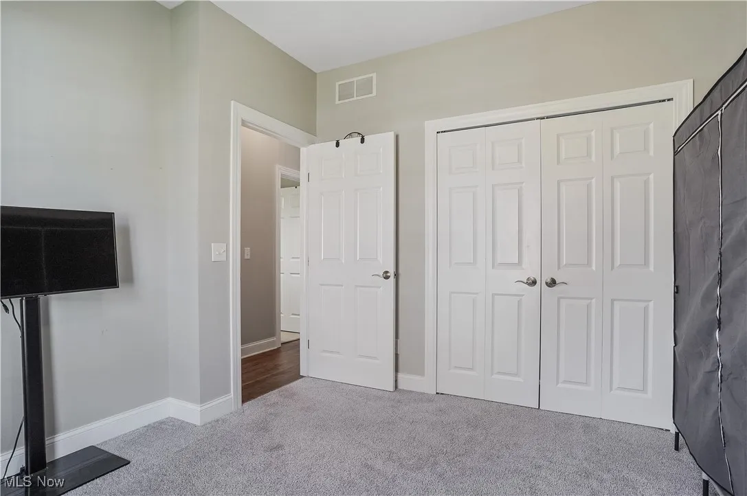 Unfurnished bedroom with carpet and a closet