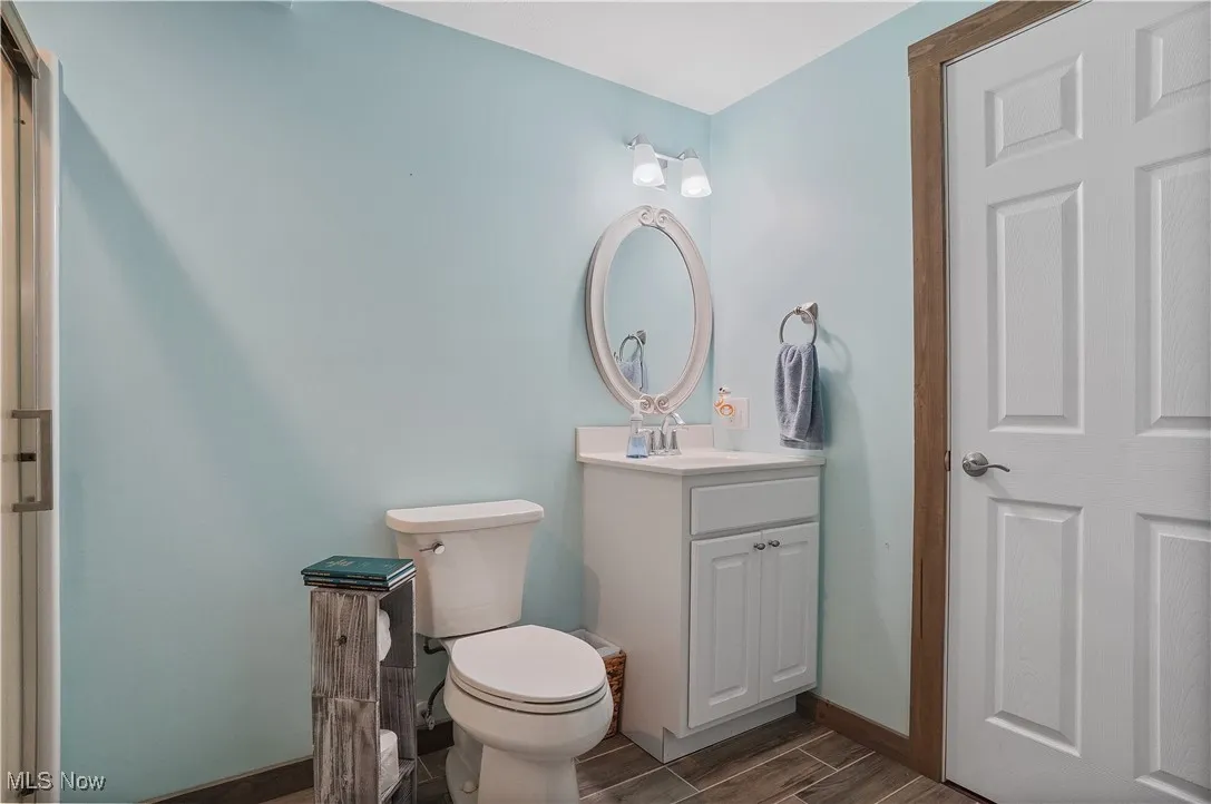 Bathroom with vanity and wood tiled floors