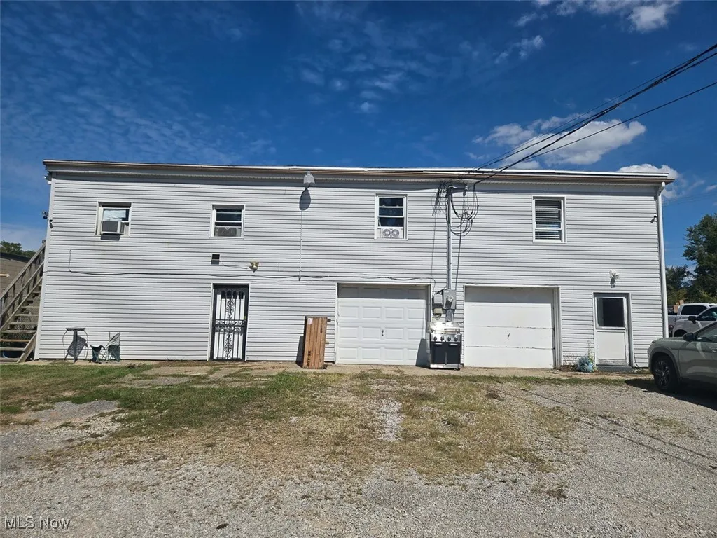Front view of house featuring stairway and a garage