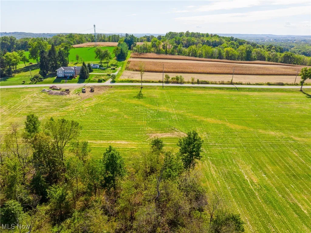 Aerial view of sparsely populated area with large plots for crops