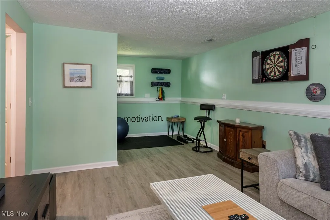 Lower level family room featuring luxury vinyl wood look flooring and includes space for a workout area or a bar