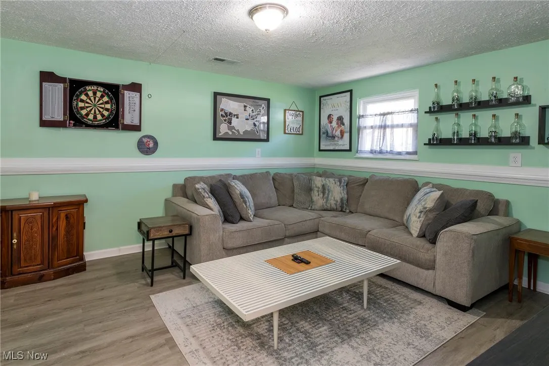 Lower level family room featuring luxury vinyl wood look flooring and room to unwind