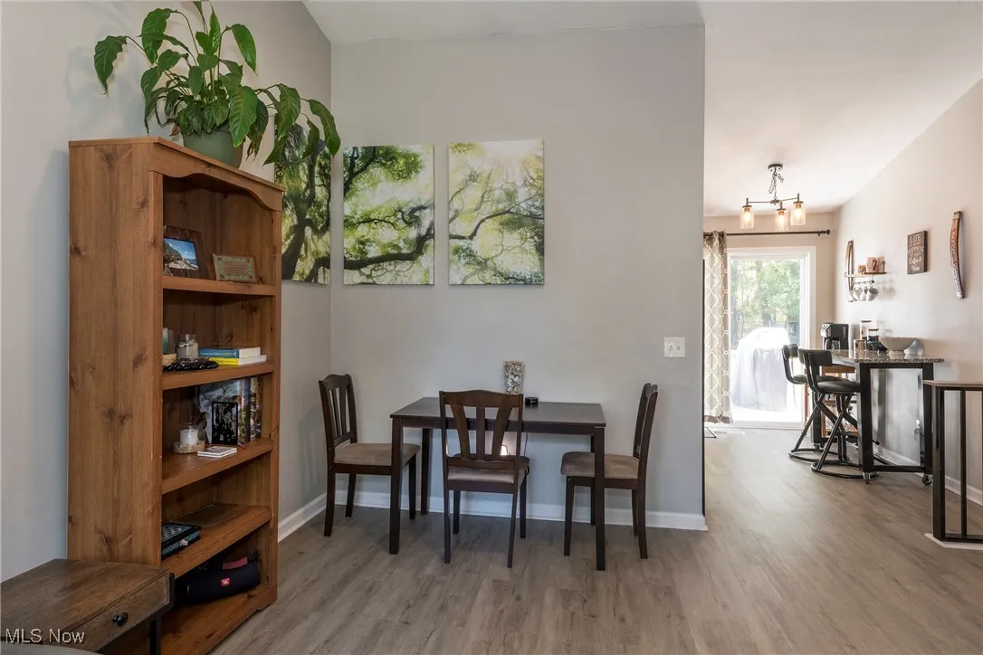 Dining room area off of living room featuring luxury vinyl wood look flooring