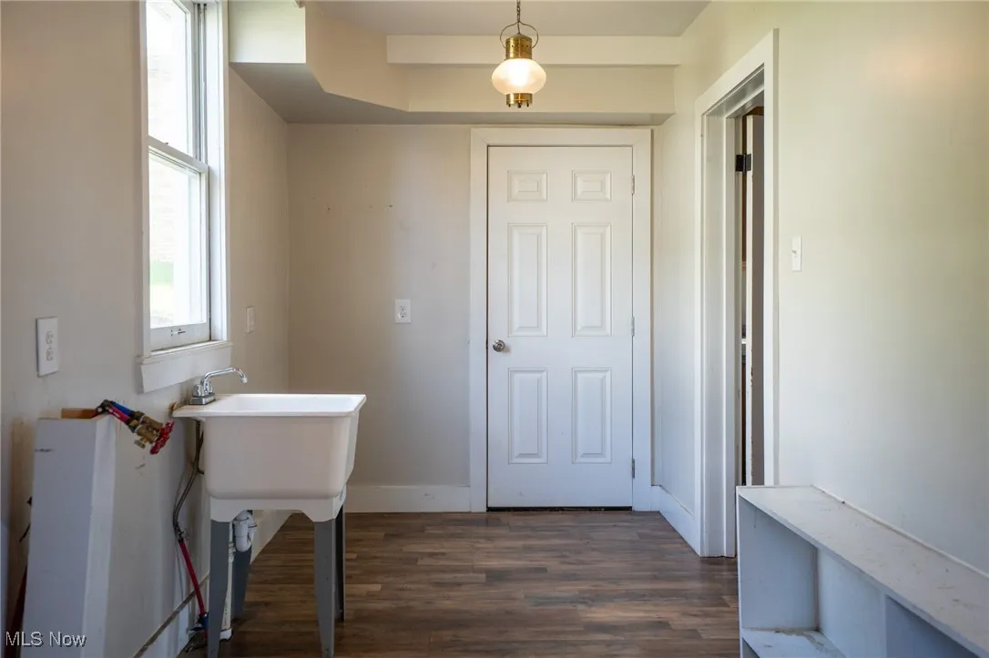 Bathroom with dark wood-type flooring and baseboards