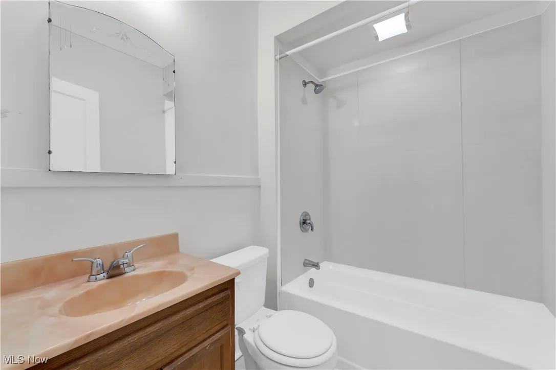 Full bathroom with shower / tub combination and vanity