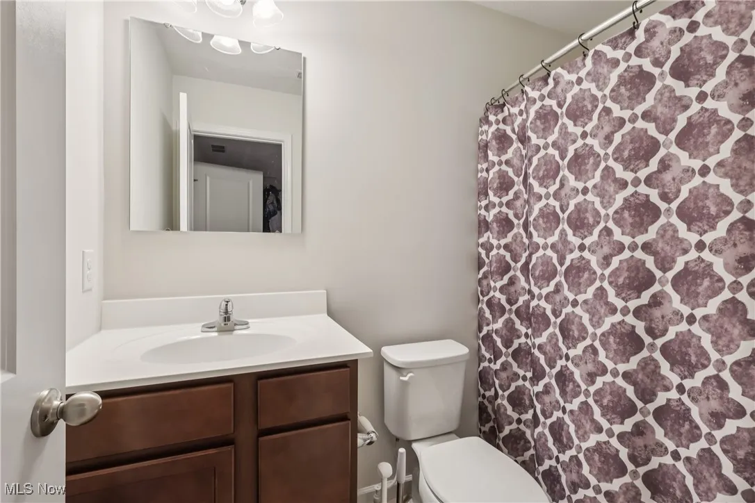 Bathroom featuring vanity and a shower with shower curtain