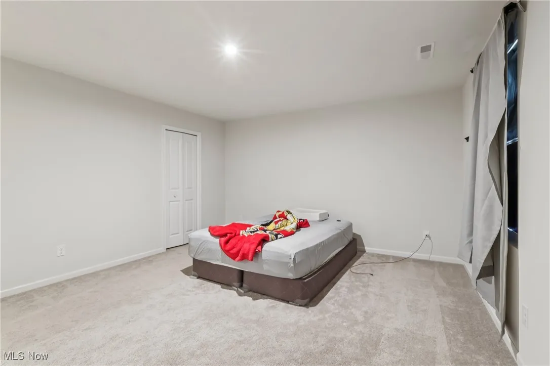 Carpeted bedroom with baseboards