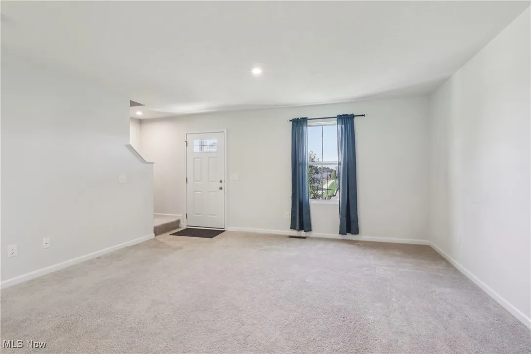 Unfurnished room featuring light colored carpet and recessed lighting