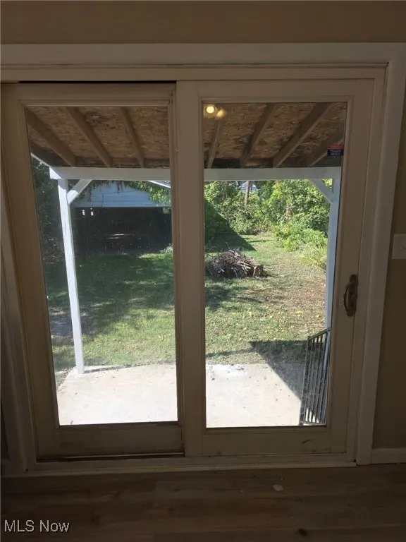 Doorway to outside featuring wood finished floors