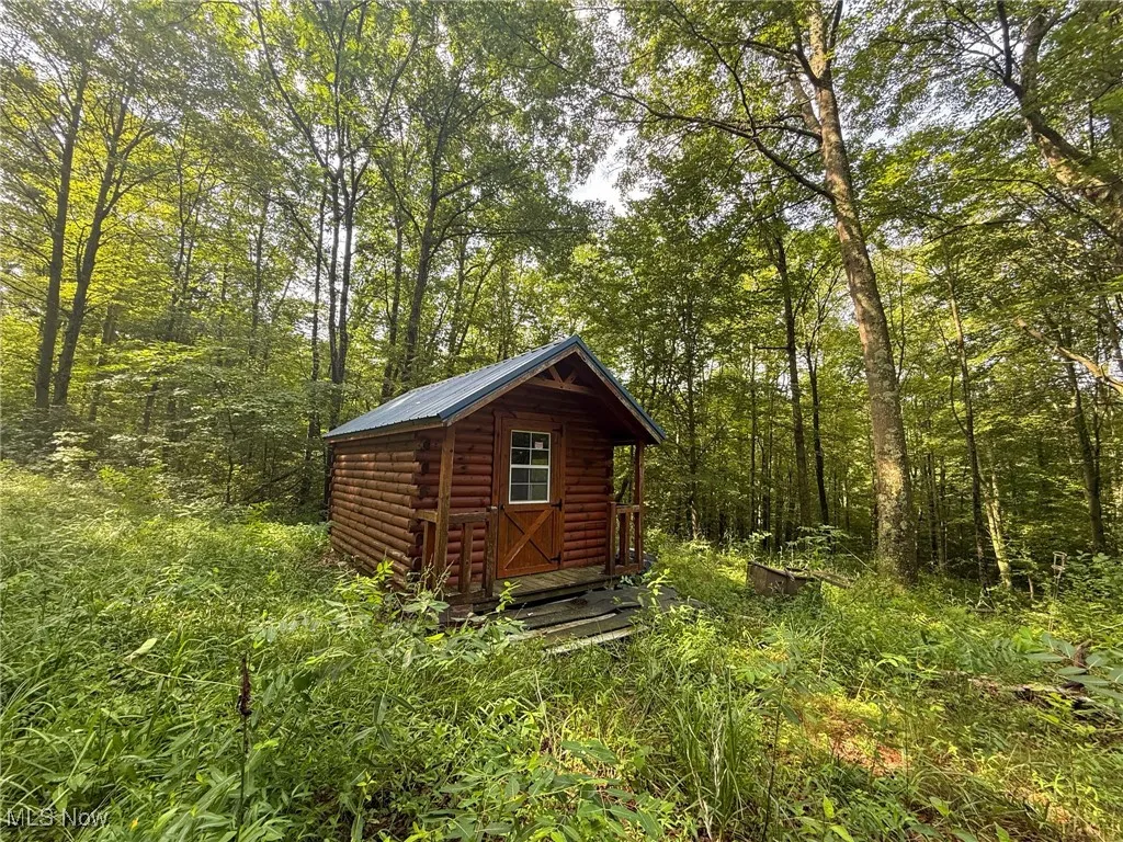 View of outdoor structure featuring a forest view
