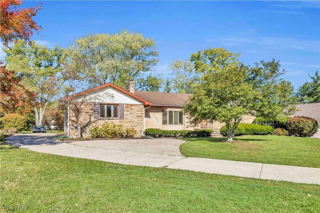 Ranch style home with stone and brick facade. Long concrete driveway with a turnaround in the front. Also lots of room for parking and turnaround in the back.