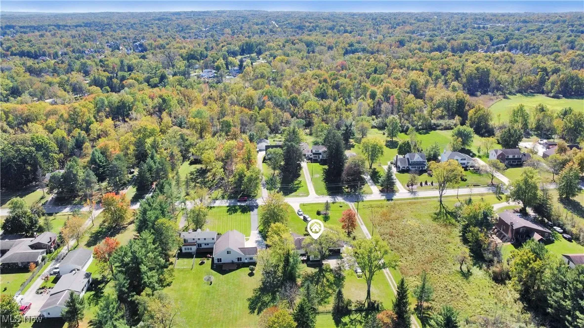 Aerial perspective of suburban area featuring a forest