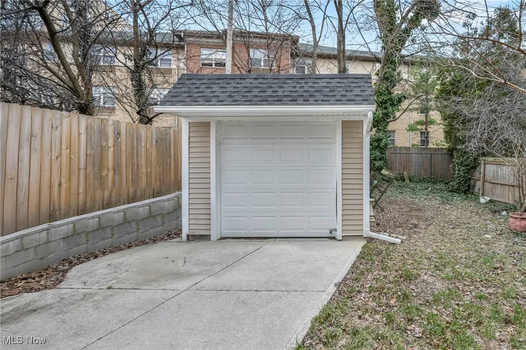 Detached garage with driveway and fence