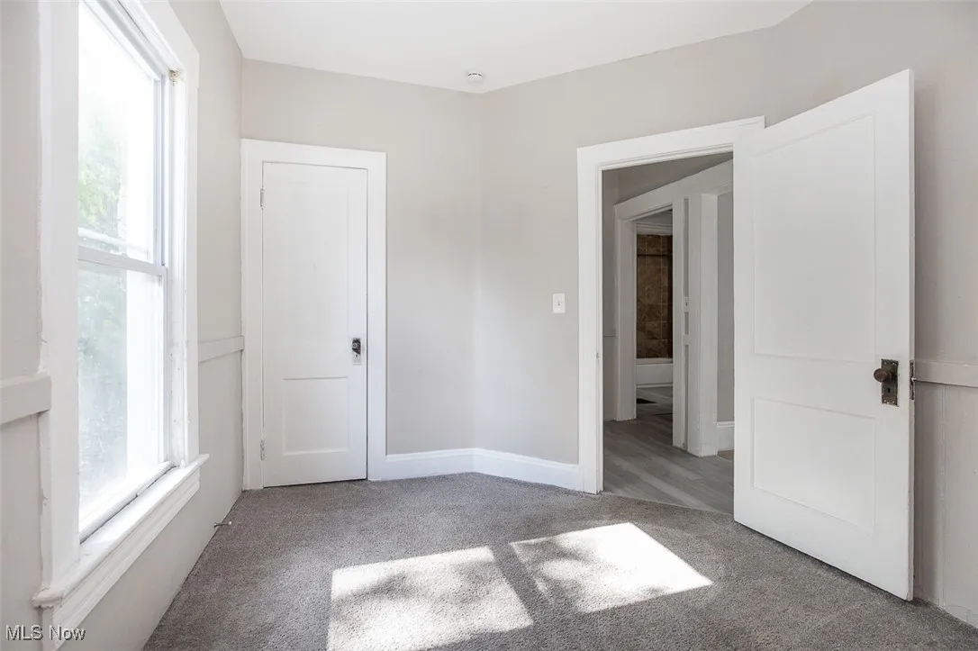 Unfurnished bedroom with light carpet