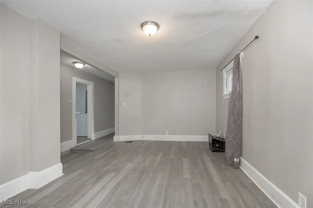 Empty room with light wood finished floors