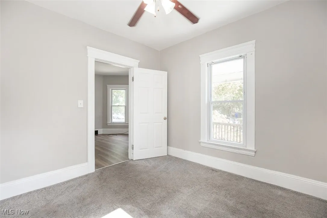 Spare room with carpet and a ceiling fan