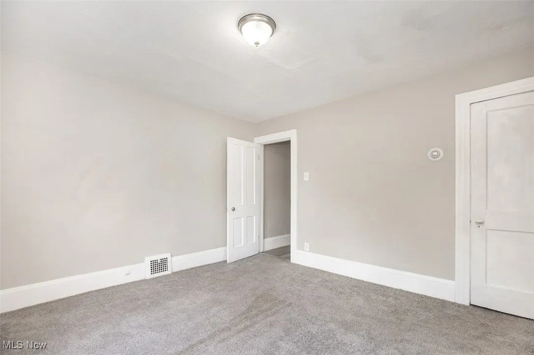 Unfurnished room featuring carpet flooring and baseboards