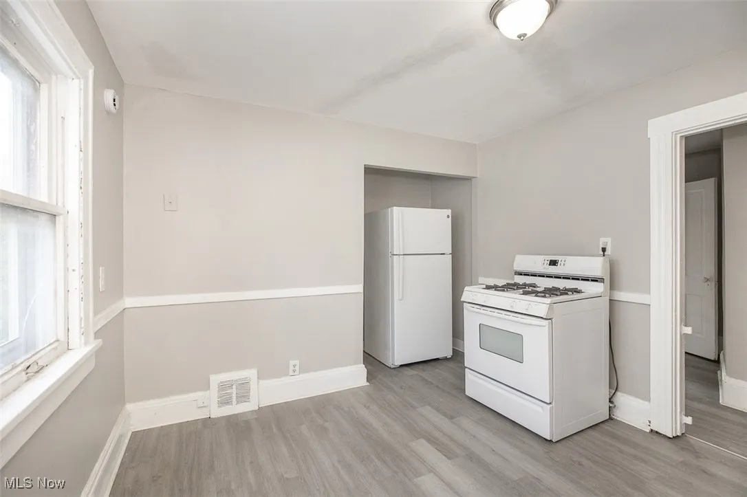 Kitchen featuring white appliances and light wood-type flooring