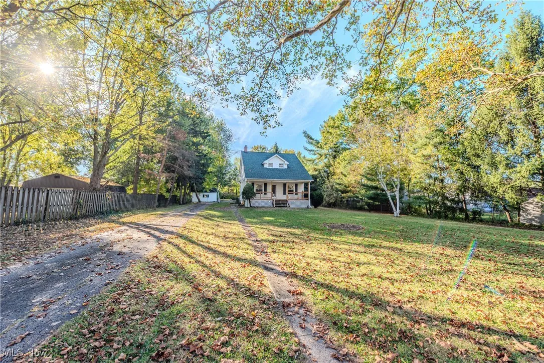View of front facade with a porch and asphalt driveway