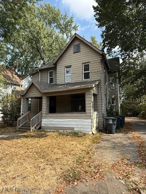 View of front facade featuring covered porch and roof with shingles