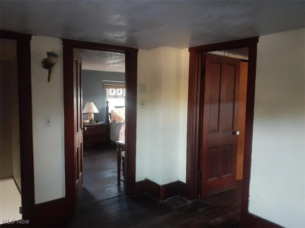 Hall featuring dark wood-style flooring