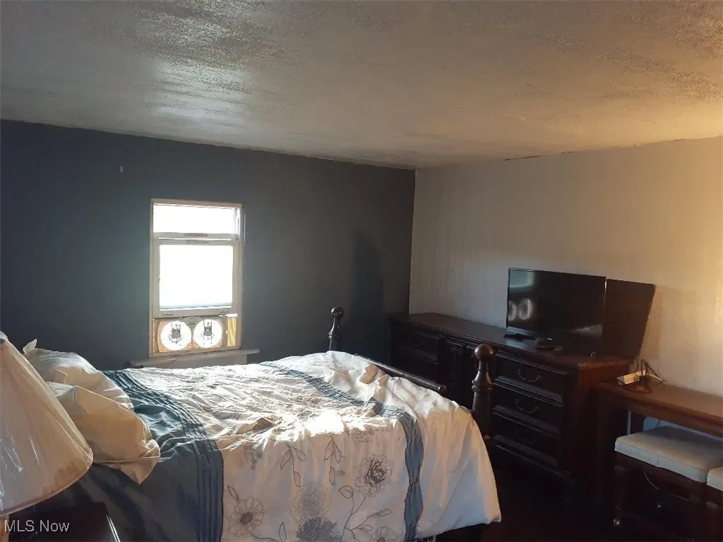 Bedroom featuring a textured ceiling