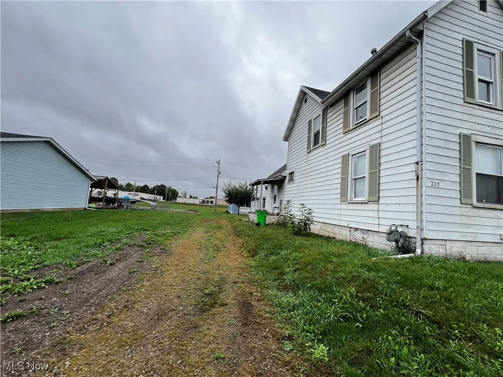 View of side of home with a lawn