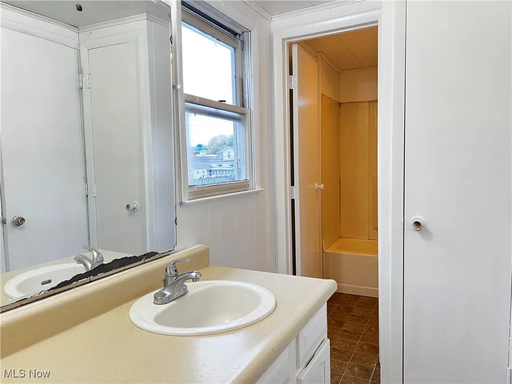 Full bathroom featuring vanity and bathtub / shower combination