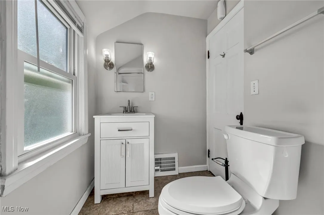 Bathroom with natural light, vanity, mirror